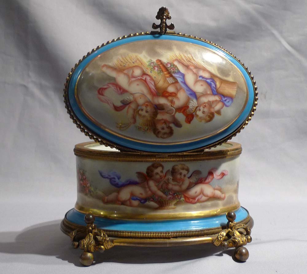 Antique French porcelain and ormolu casket with hand painted scenes of cupids..