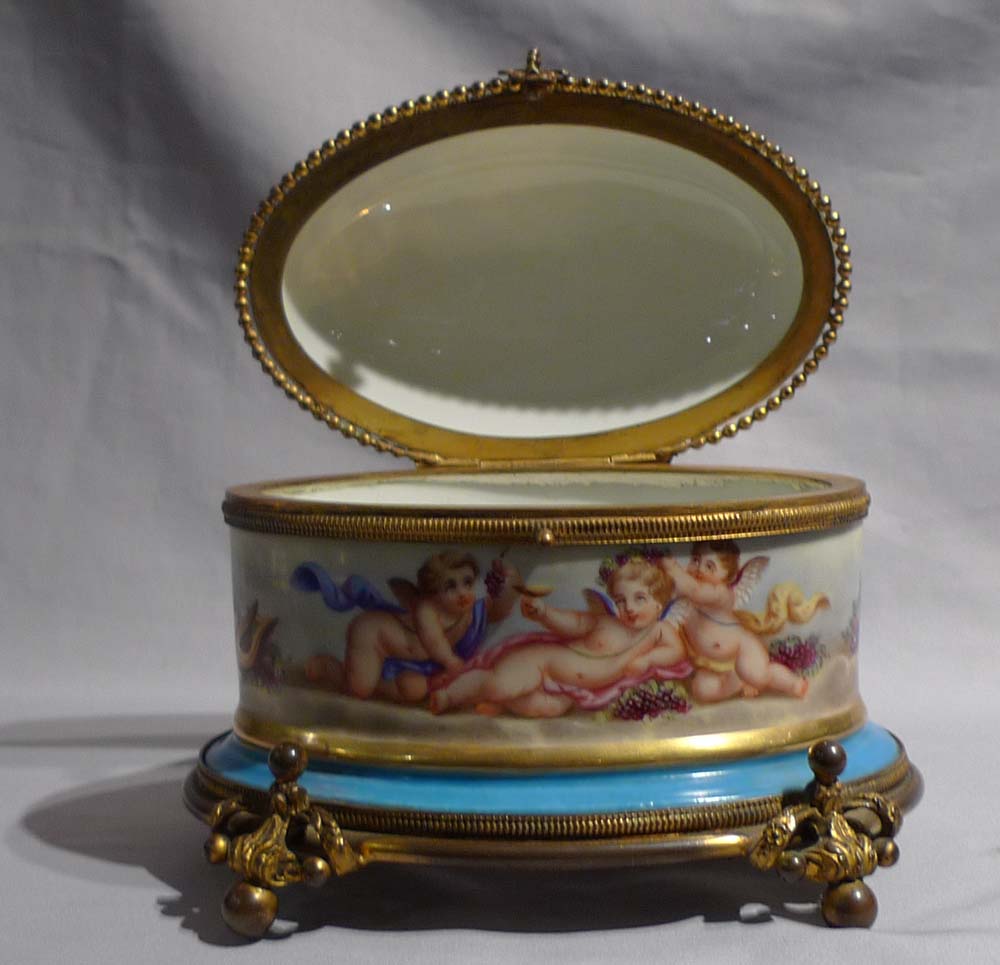 Antique French porcelain and ormolu casket with hand painted scenes of cupids..