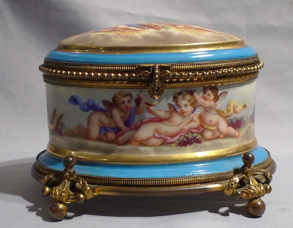 Antique French porcelain and ormolu casket with hand painted scenes of cupids..
