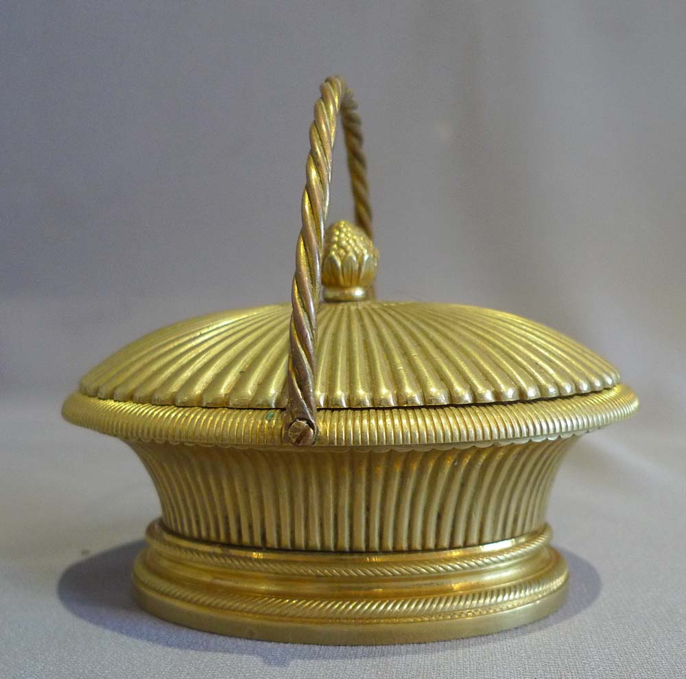 Antique ormolu inkwell modelled as a lidded basket.