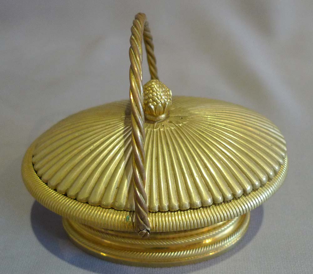 Antique ormolu inkwell modelled as a lidded basket.