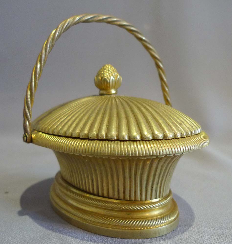 Antique ormolu inkwell modelled as a lidded basket.