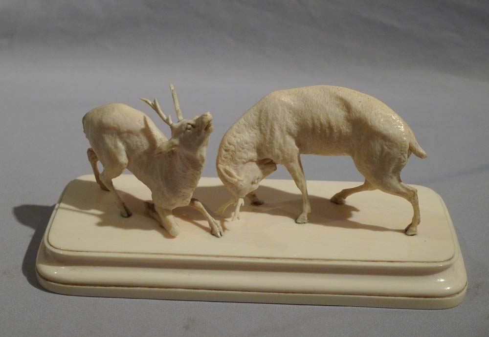 Antique ivory sculpture of stags fighting in the Rut.
