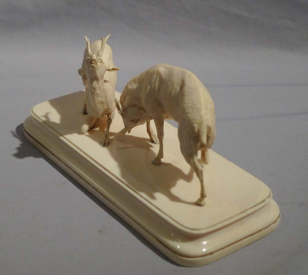 Antique ivory sculpture of stags fighting in the Rut.