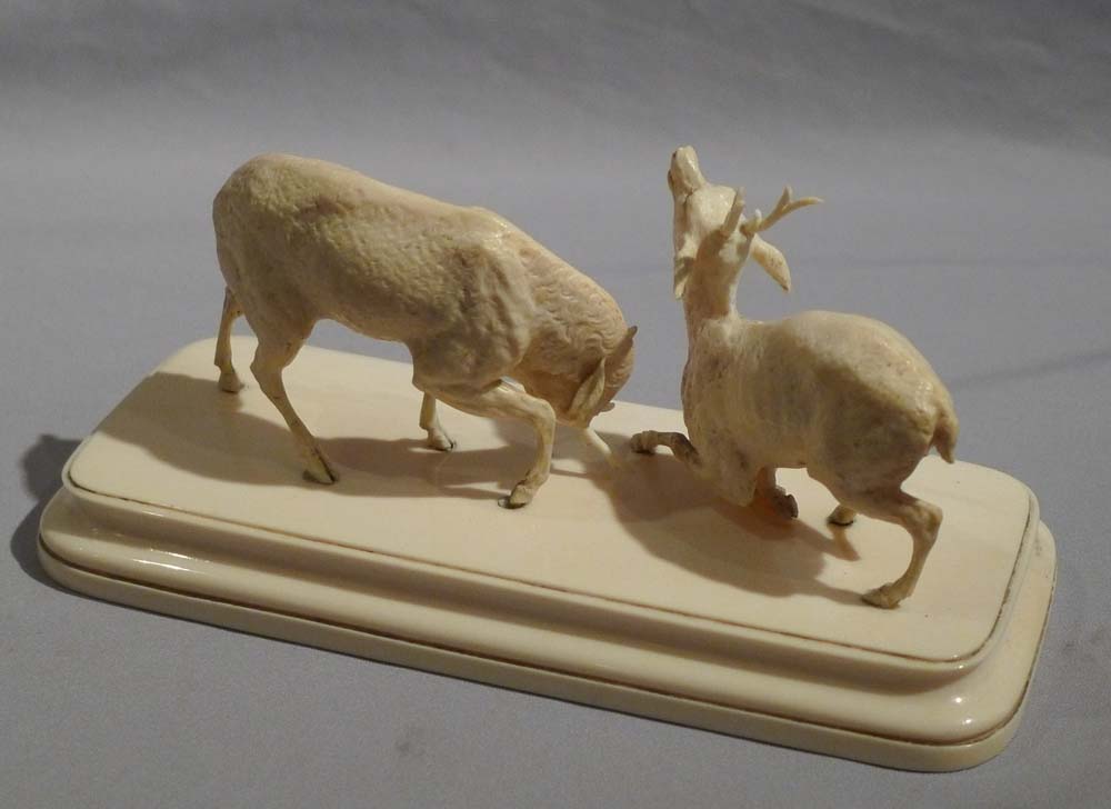 Antique ivory sculpture of stags fighting in the Rut.