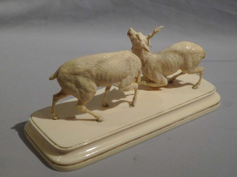 Antique ivory sculpture of stags fighting in the Rut.