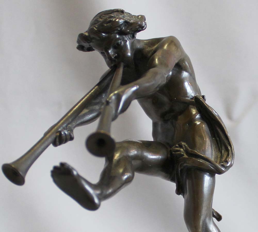 Antique bronze of a satyr playing pipes on Sienna marble base signed Bulio.