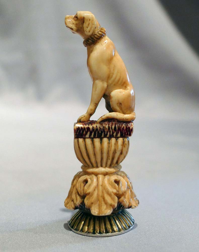 Antique seal in form of a seated dog in silver and ivory.