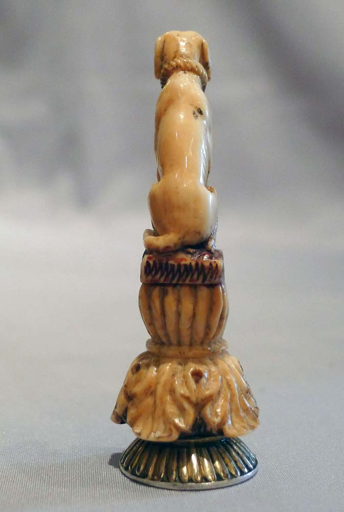 Antique seal in form of a seated dog in silver and ivory.