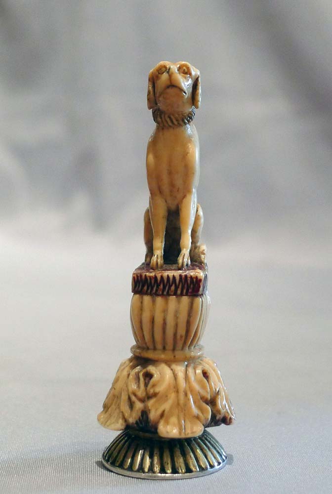Antique seal in form of a seated dog in silver and ivory.