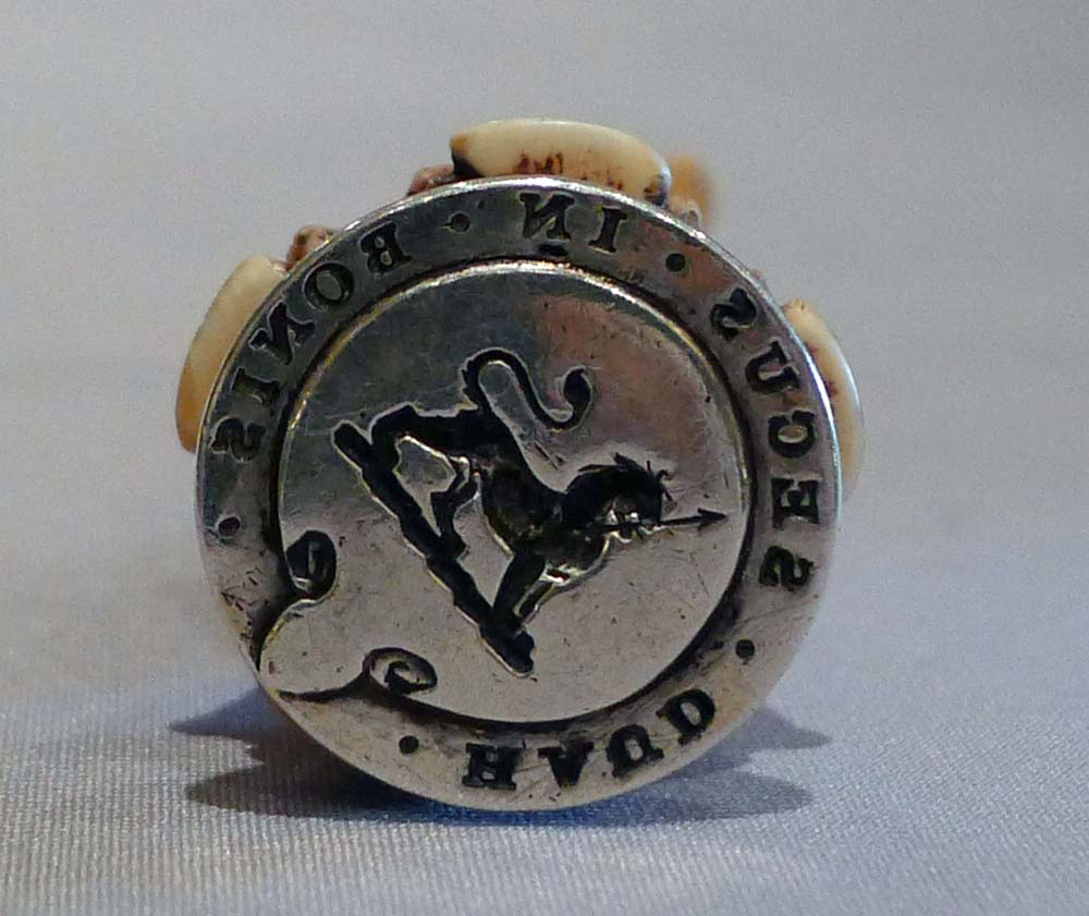 Antique seal in form of a seated dog in silver and ivory.