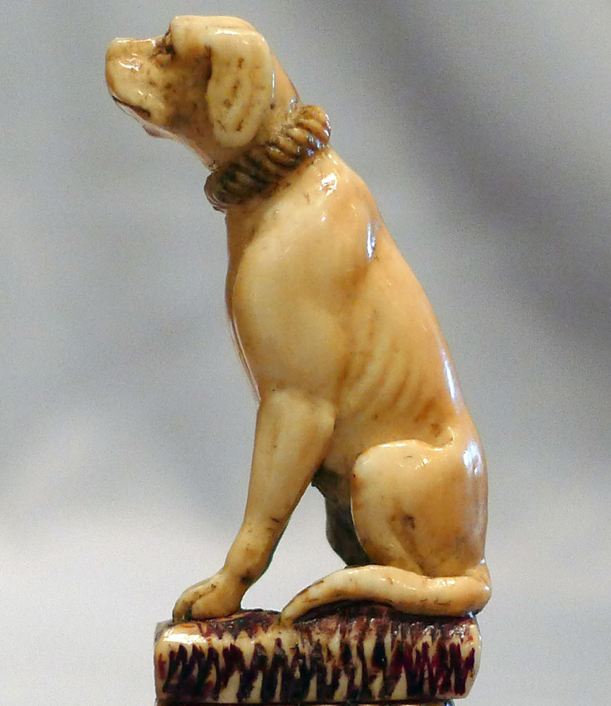 Antique seal in form of a seated dog in silver and ivory.