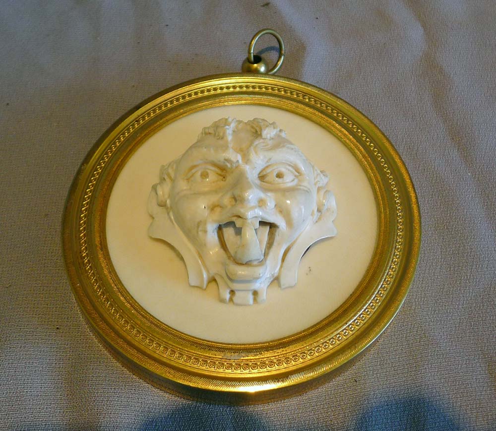 Antique French Dieppe ivory grotesque in a fine ormou frame.