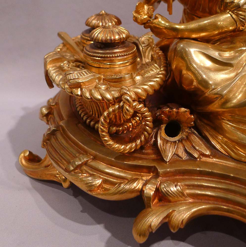 Antique gilt bronze desk standish with a reclining lady.