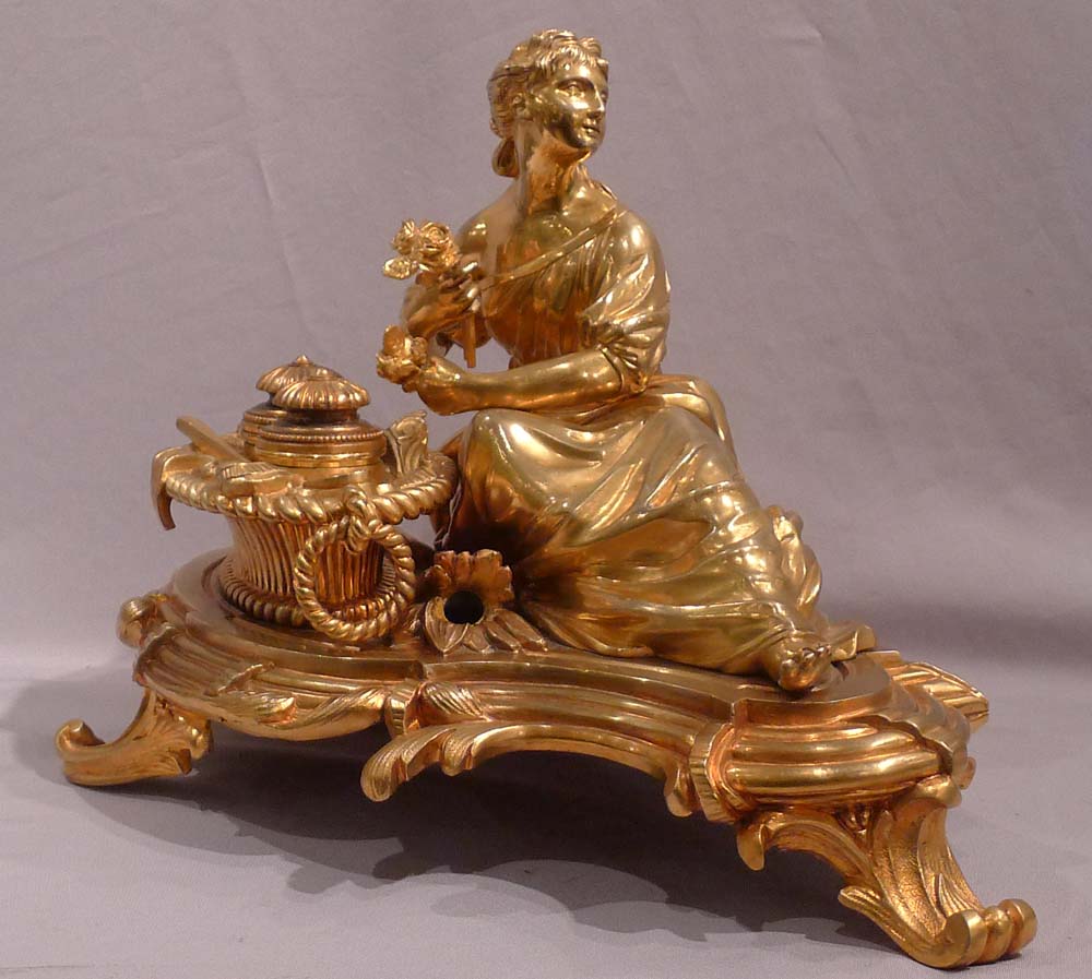 Antique gilt bronze desk standish with a reclining lady.
