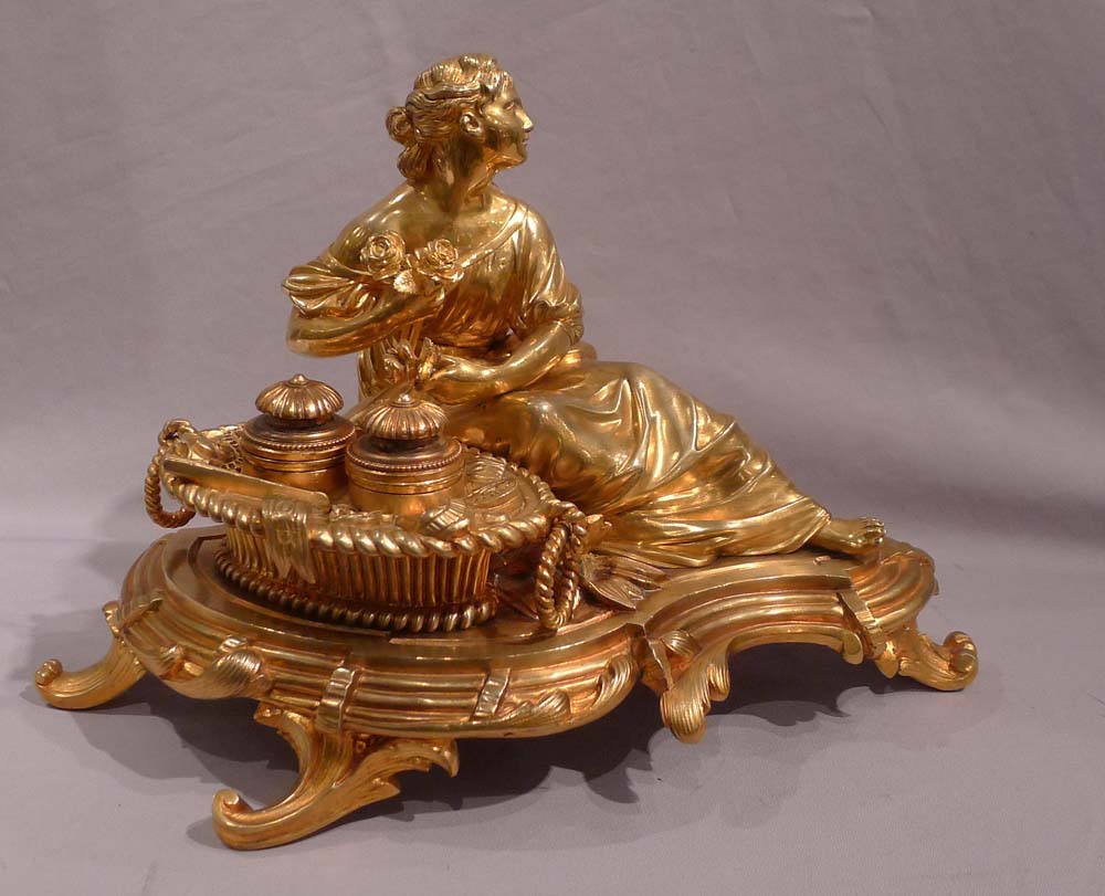 Antique gilt bronze desk standish with a reclining lady.