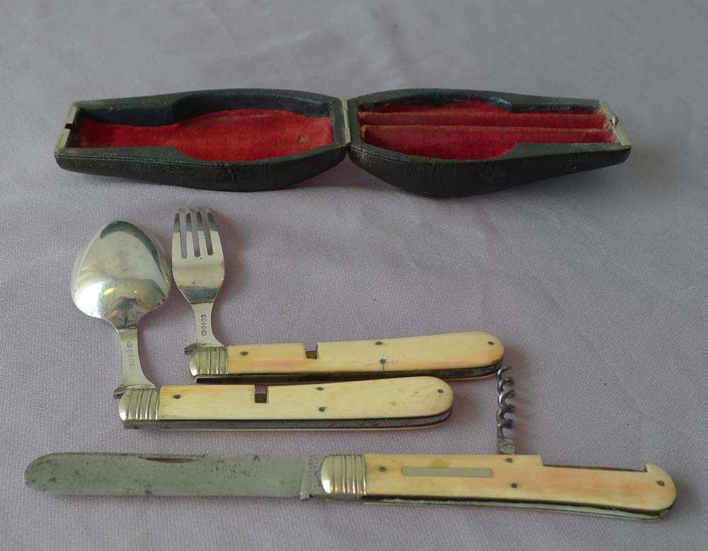 Antique shagreen cased travelling knife, fork and spoon in ivory, silver and steel.