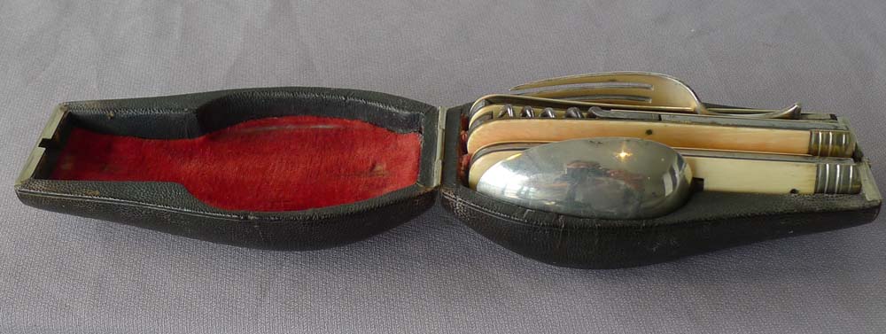 Antique shagreen cased travelling knife, fork and spoon in ivory, silver and steel.