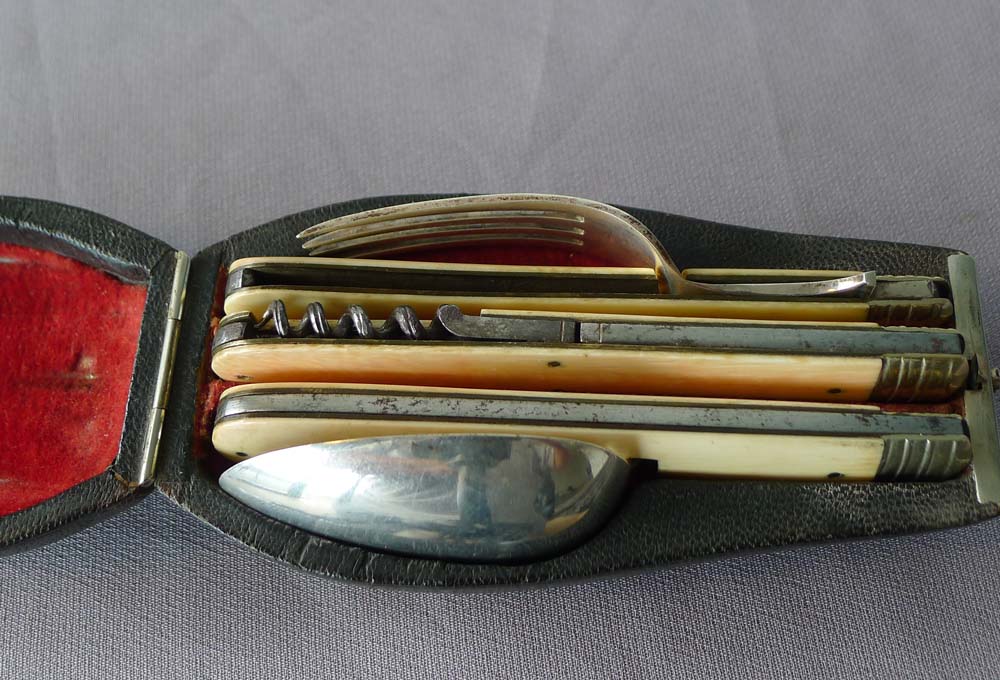 Antique shagreen cased travelling knife, fork and spoon in ivory, silver and steel.