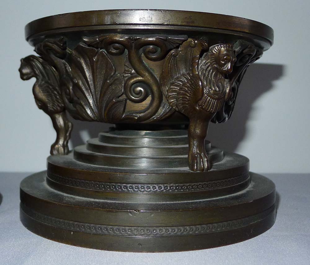 A patinated bronze figural inkwell with the detachable cover applied with Knights fighting on horses