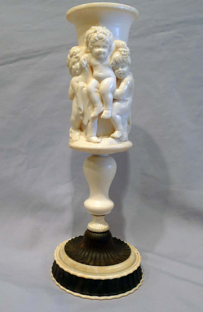 Antique ivory cup on stand.