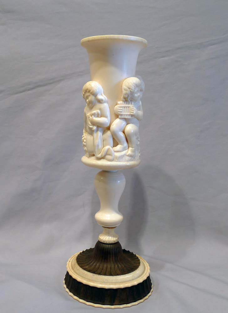 Antique ivory cup on stand.