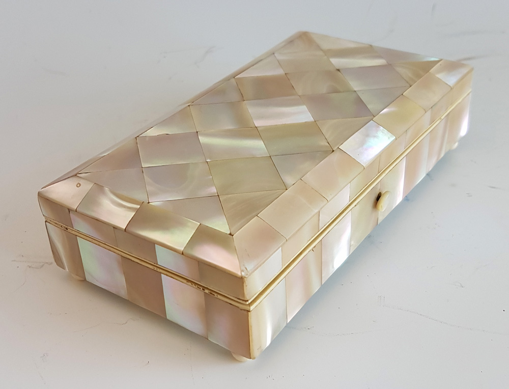 Antique French Napoleon III mother of pearl box with ivory stringing and bun feet.