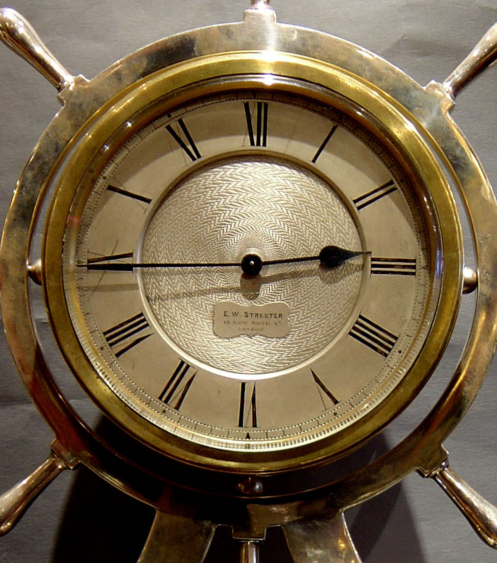 Antique English silver & ebonized ships wheel clock.