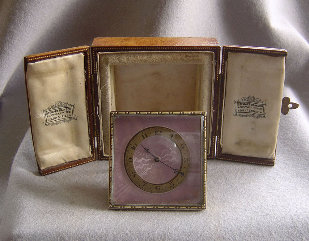 Lilac enamel and gilt bronze strut clock in original case.