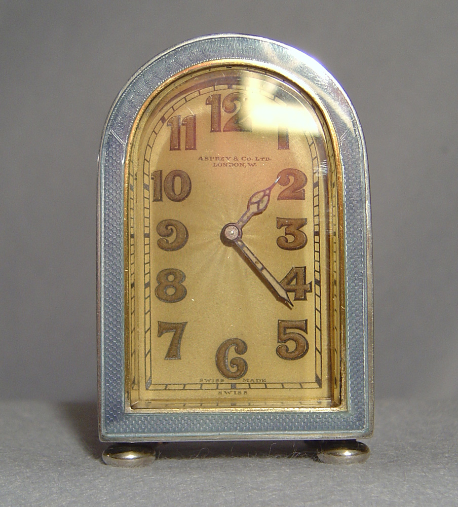 A fine Art Deco silver gilt and lilac guilloche enamel boudoir clock by Asprey's of London.