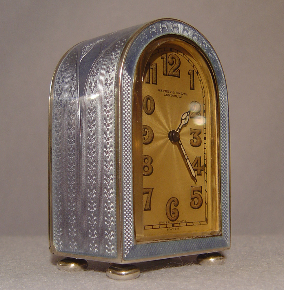 A fine Art Deco silver gilt and lilac guilloche enamel boudoir clock by Asprey's of London.