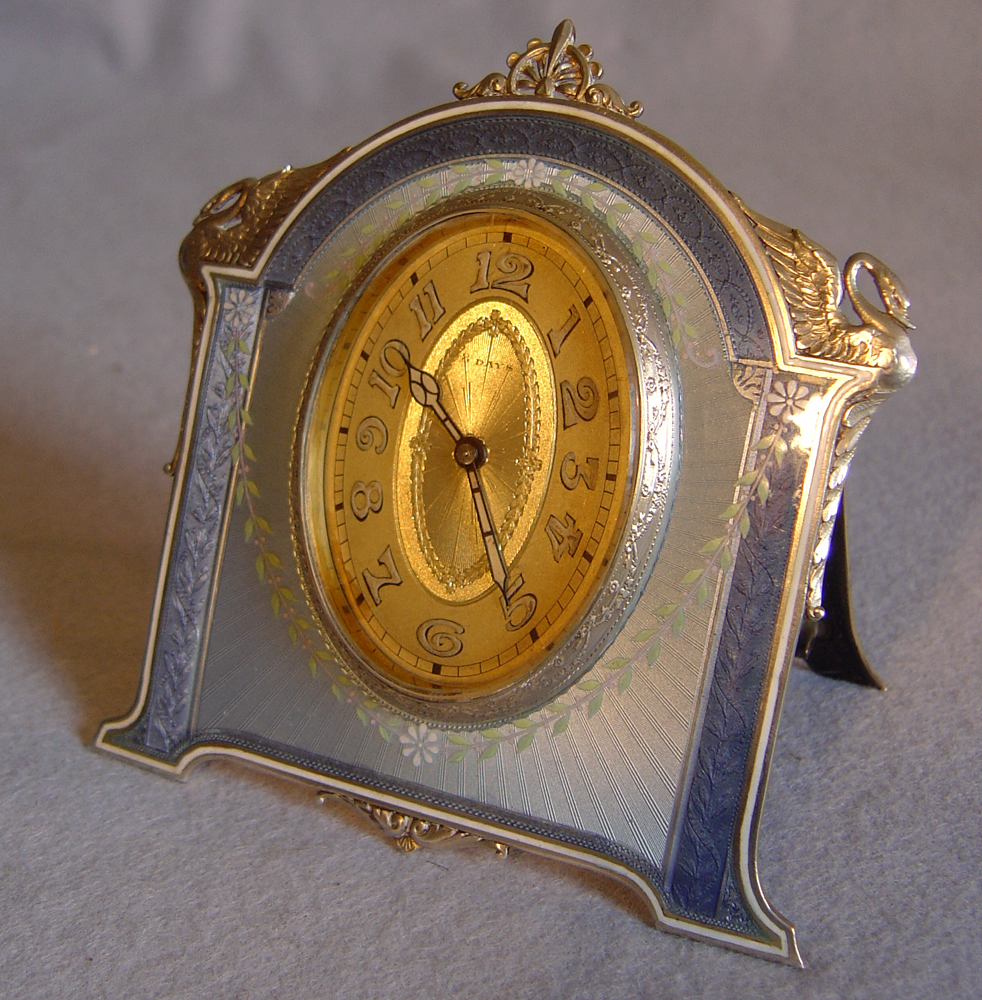 Fine Swiss silver and guilloche enamel strut clock.
