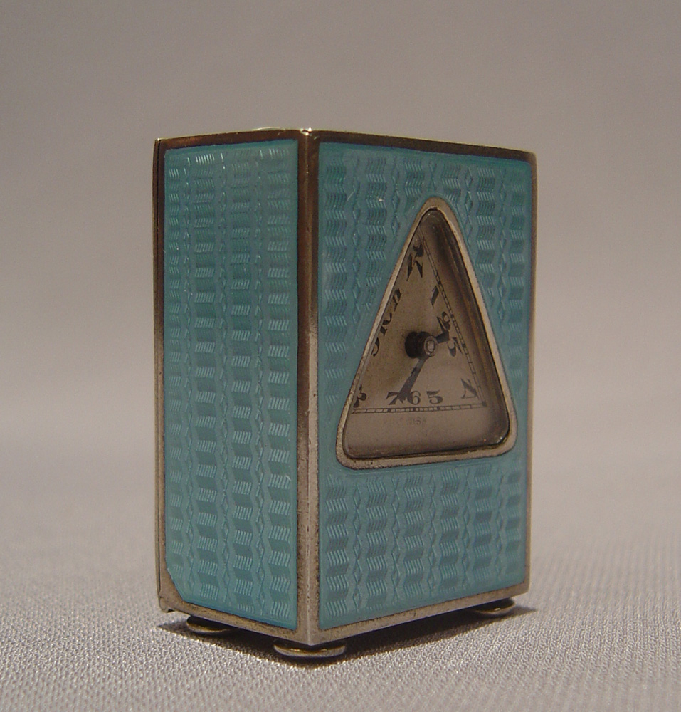 Silver and blue guilloche enamel miniature carriage clock with triangular dial.