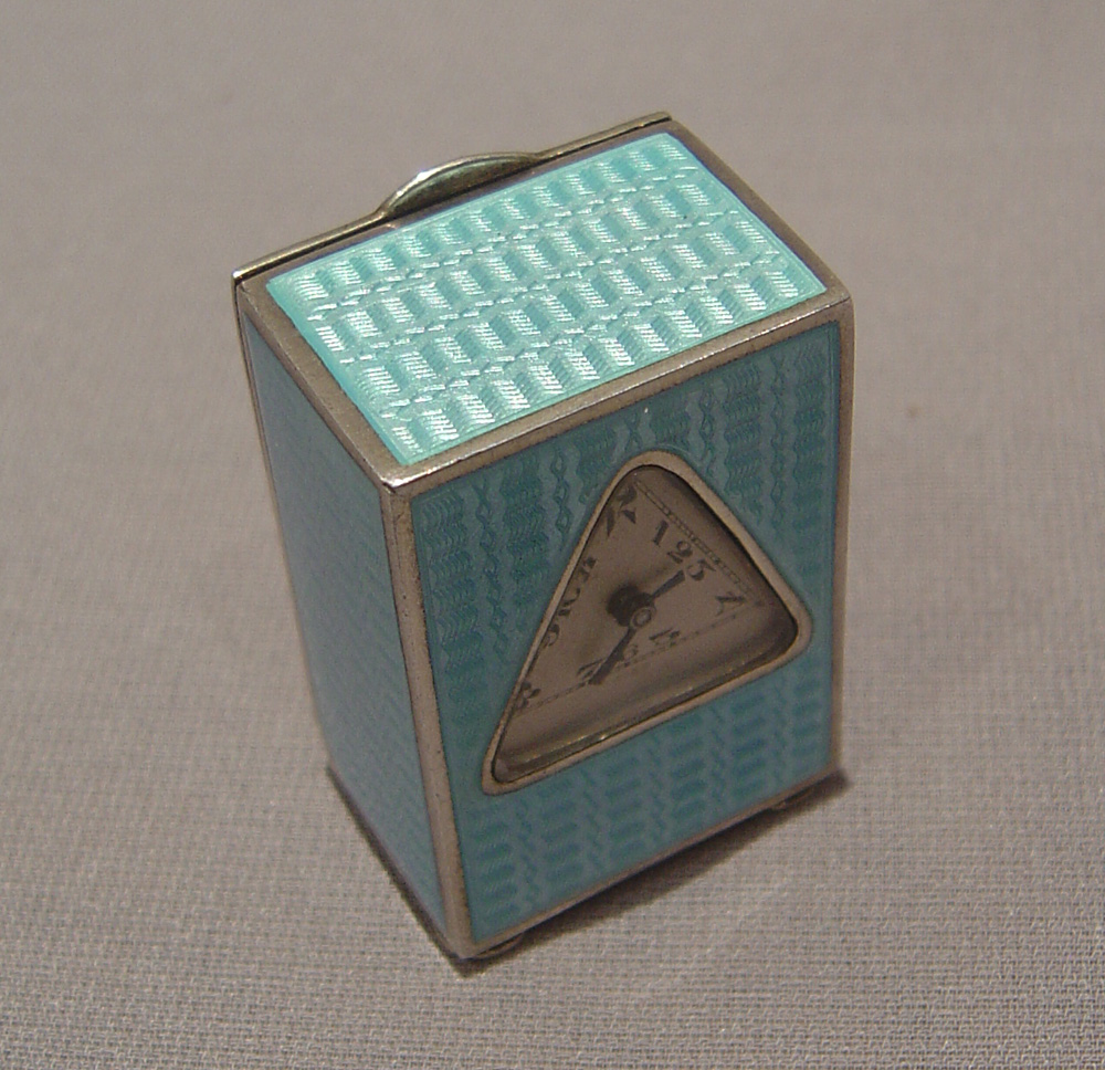 Silver and blue guilloche enamel miniature carriage clock with triangular dial.