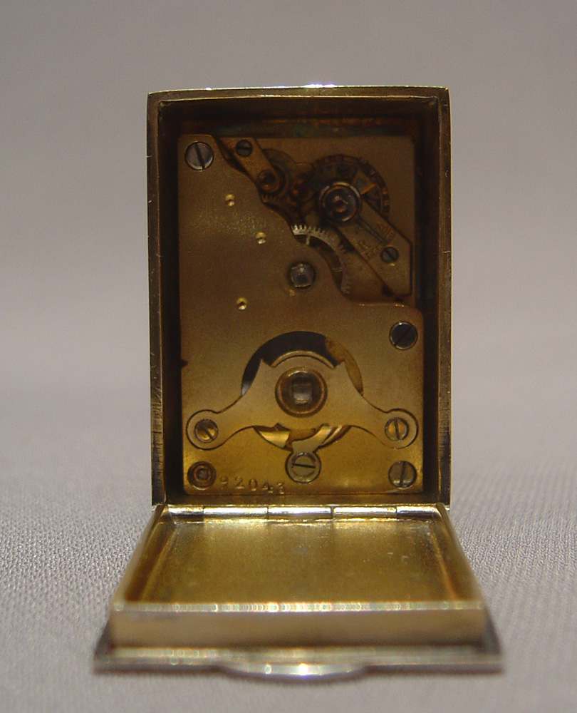 Silver and blue guilloche enamel miniature carriage clock with triangular dial.
