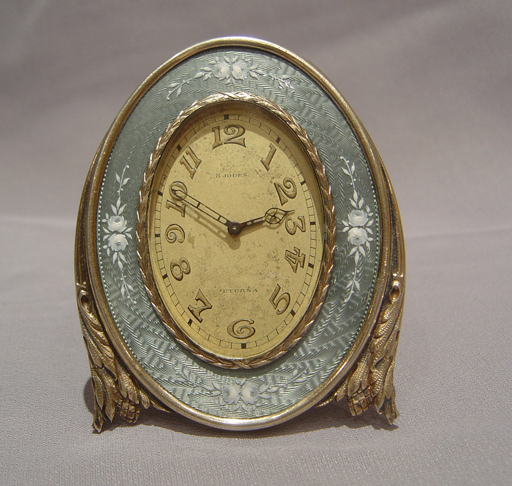 Silver and grey guilloche enamel strut clock with hand painted flowers.