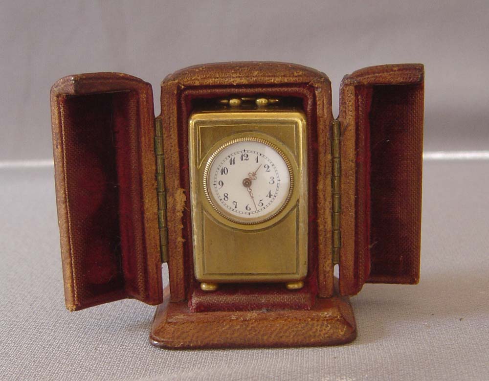 Antique miniature carriage clock in original leather case.