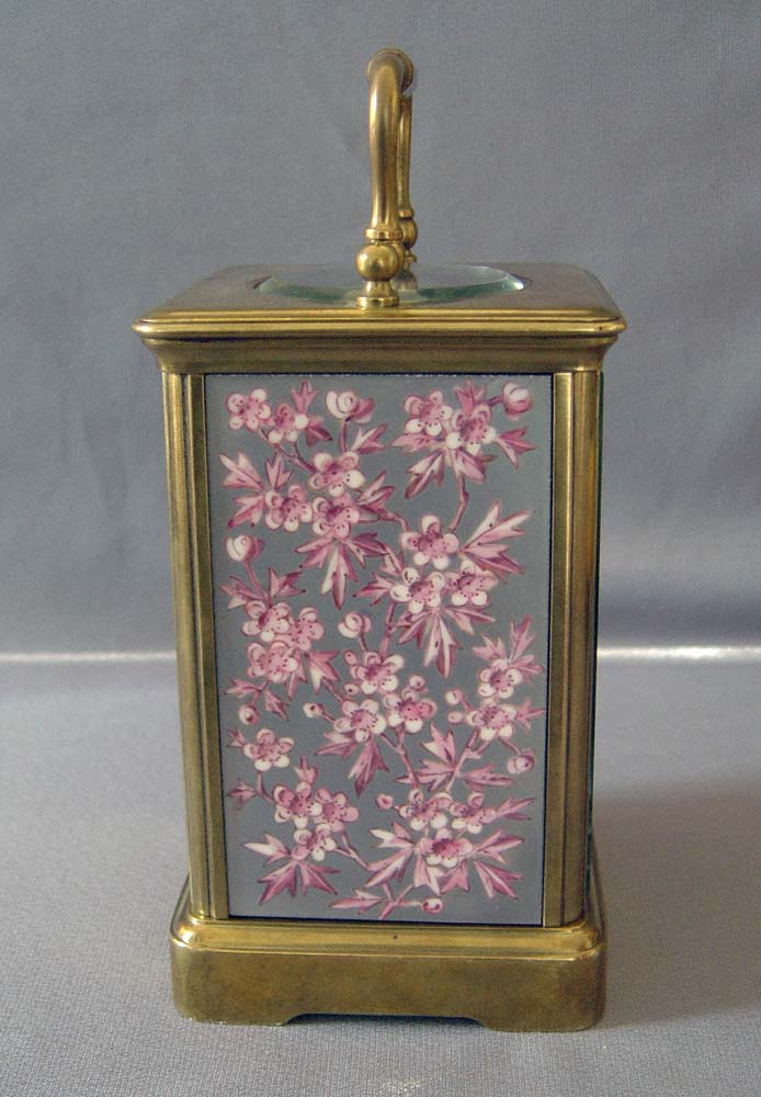 Antique porcelain panelled French carriage clock with apple blossom decoration.