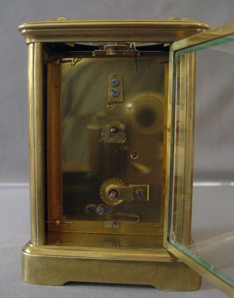 Antique porcelain panelled French carriage clock with apple blossom decoration.