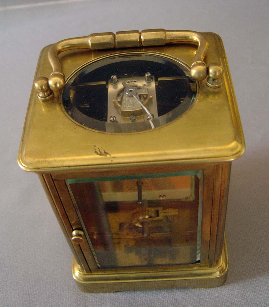 Antique porcelain panelled French carriage clock with apple blossom decoration.