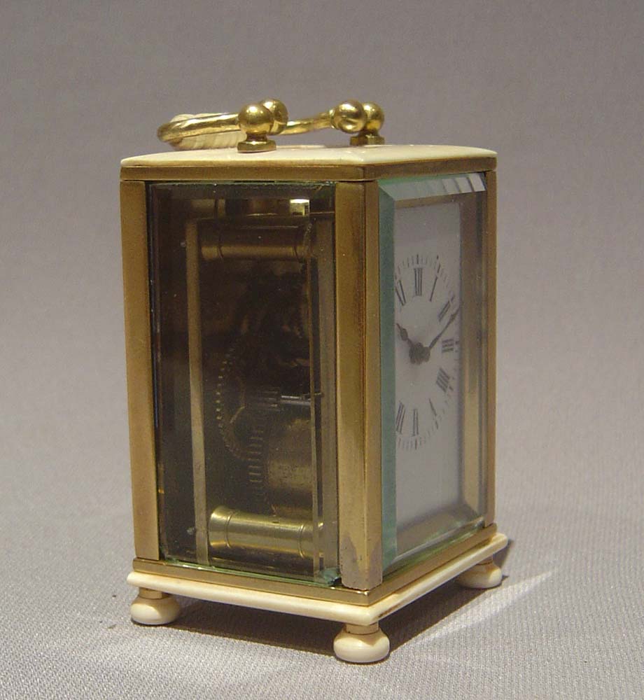 Ivory and gilt bronze carriage clock of small size.