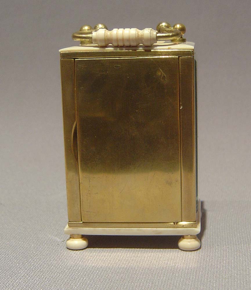 Ivory and gilt bronze carriage clock of small size.
