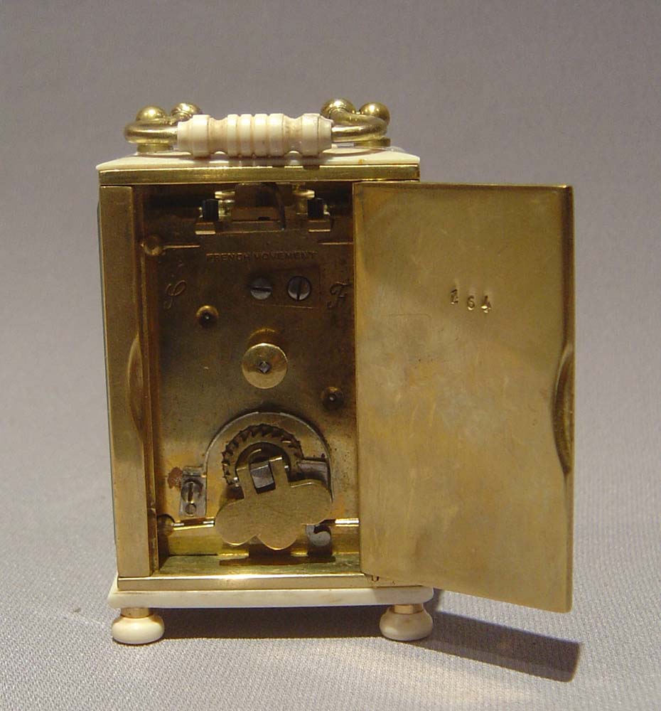 Ivory and gilt bronze carriage clock of small size.