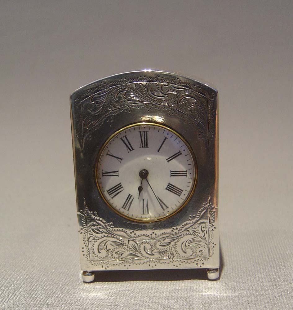 Antique victorian silver carriage clock, engraved decoration and with original travelling case.