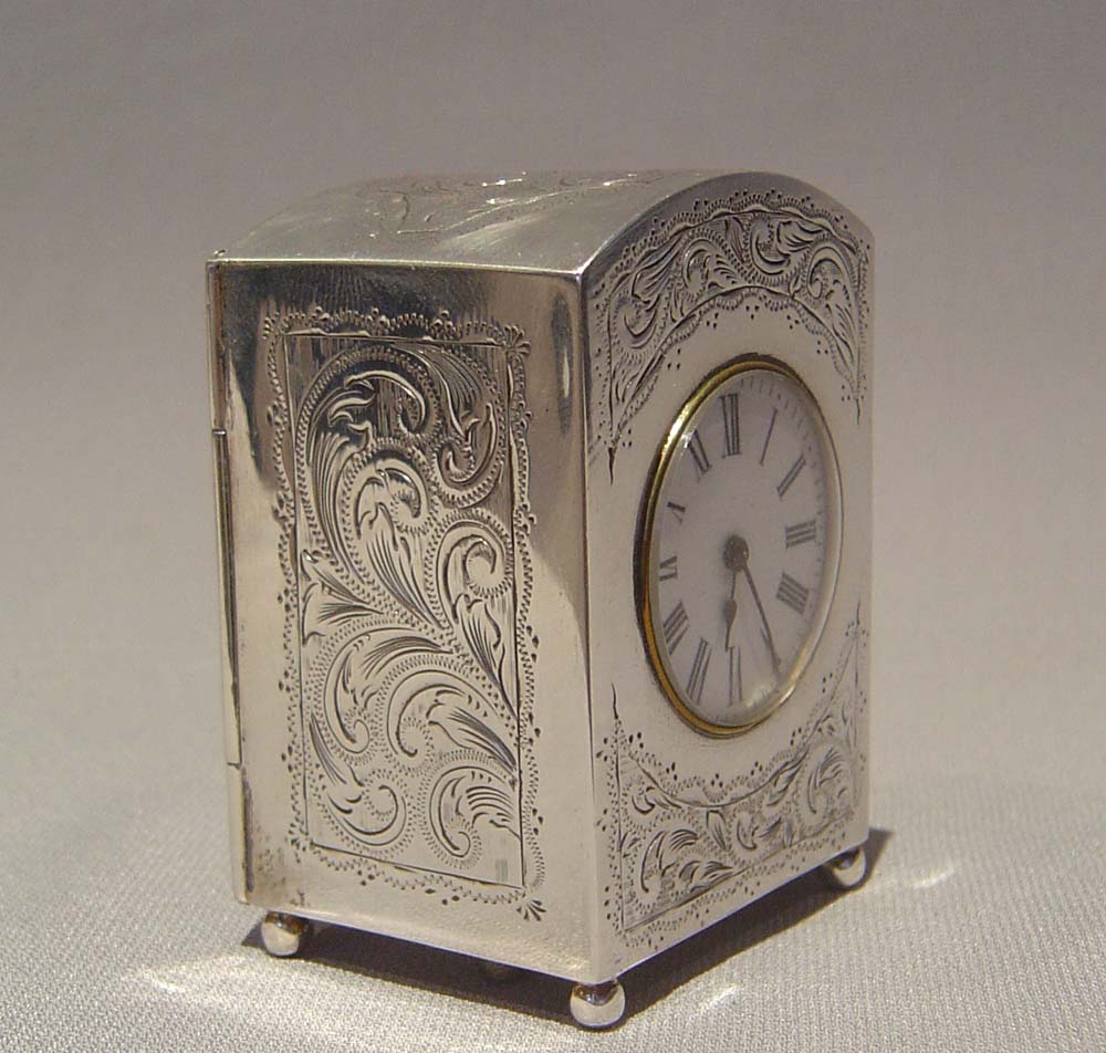 Antique victorian silver carriage clock, engraved decoration and with original travelling case.