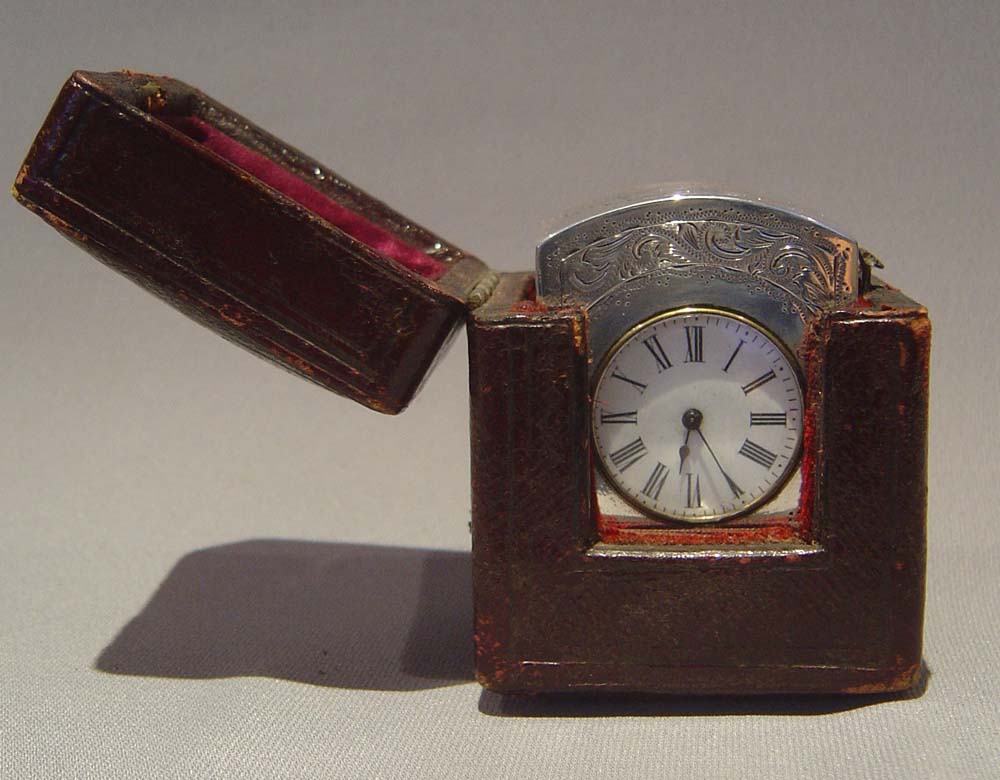 Antique victorian silver carriage clock, engraved decoration and with original travelling case.
