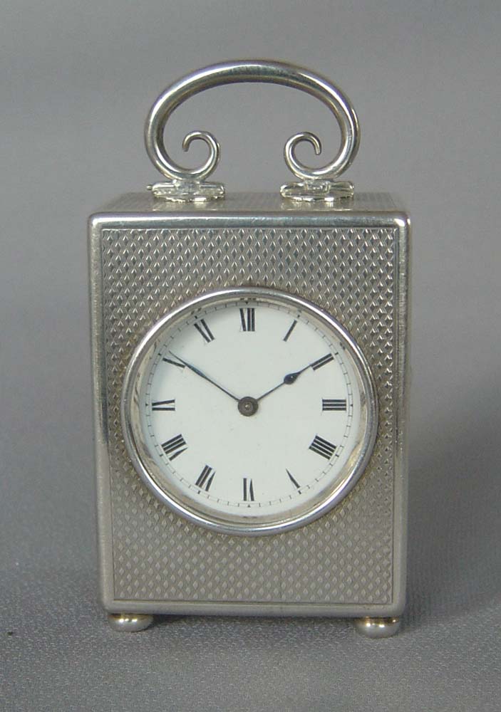 Silver engine turned small carriage clock of exceptional quality.