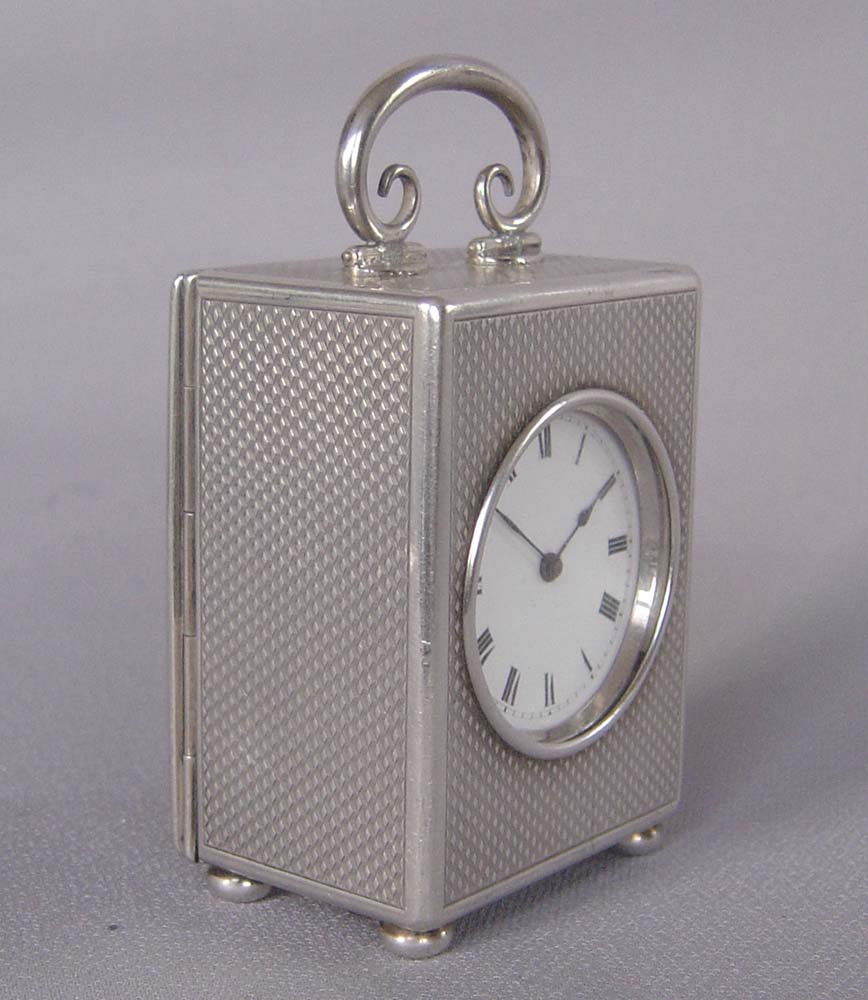 Silver engine turned small carriage clock of exceptional quality.