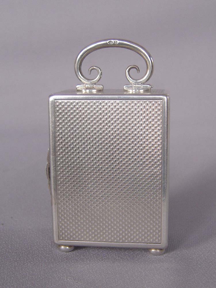 Silver engine turned small carriage clock of exceptional quality.