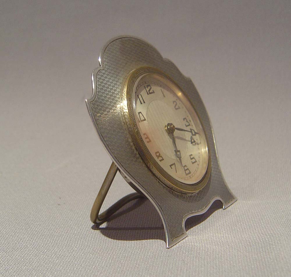 Silver strut clock with engine turned shield shaped case, 1931.